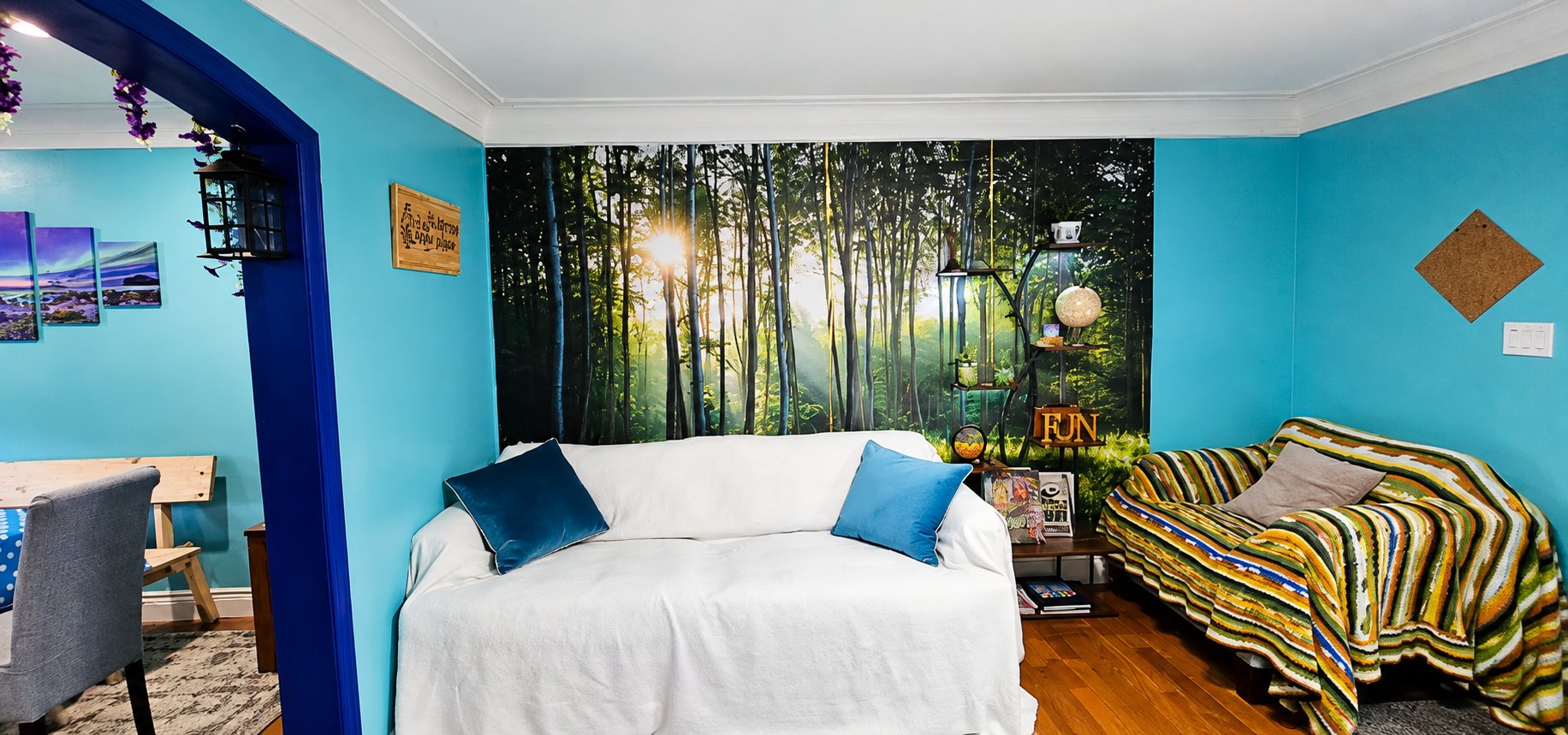 Sofa lounge corner with a forest mural wall — a place to rest between steam sessions